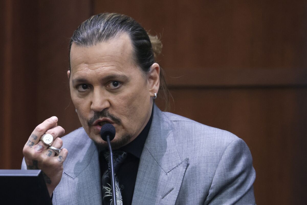 Actor Johnny Depp testifies during a hearing in the courtroom at the Fairfax County Circuit Court in Fairfax, Va., Wednesday, April 20, 2022. Actor Johnny Depp sued his ex-wife Amber Heard for libel in Fairfax County Circuit Court after she wrote an op-ed piece in The Washington Post in 2018 referring to herself as a "public figure representing domestic abuse." (Evelyn Hockstein/Pool via AP)