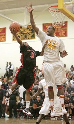 Westchester point guard Dominique O'Connor, all 5-foot-10 of him, tries to get a shot off against the defense of Fairfax's 6-11 center Renardo Sidney in the second half Friday night. O'Connor finished with 22 points to lead the Comets, and Sidney had 34 points and nine rebounds.