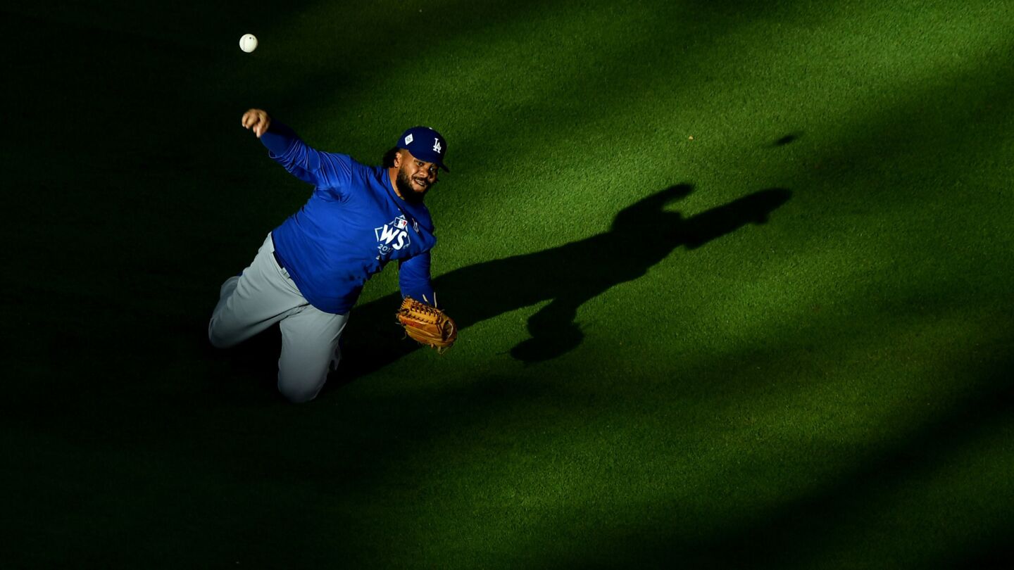 Dodgers reliever Kenley Jansen throws from his knees during batting practice.