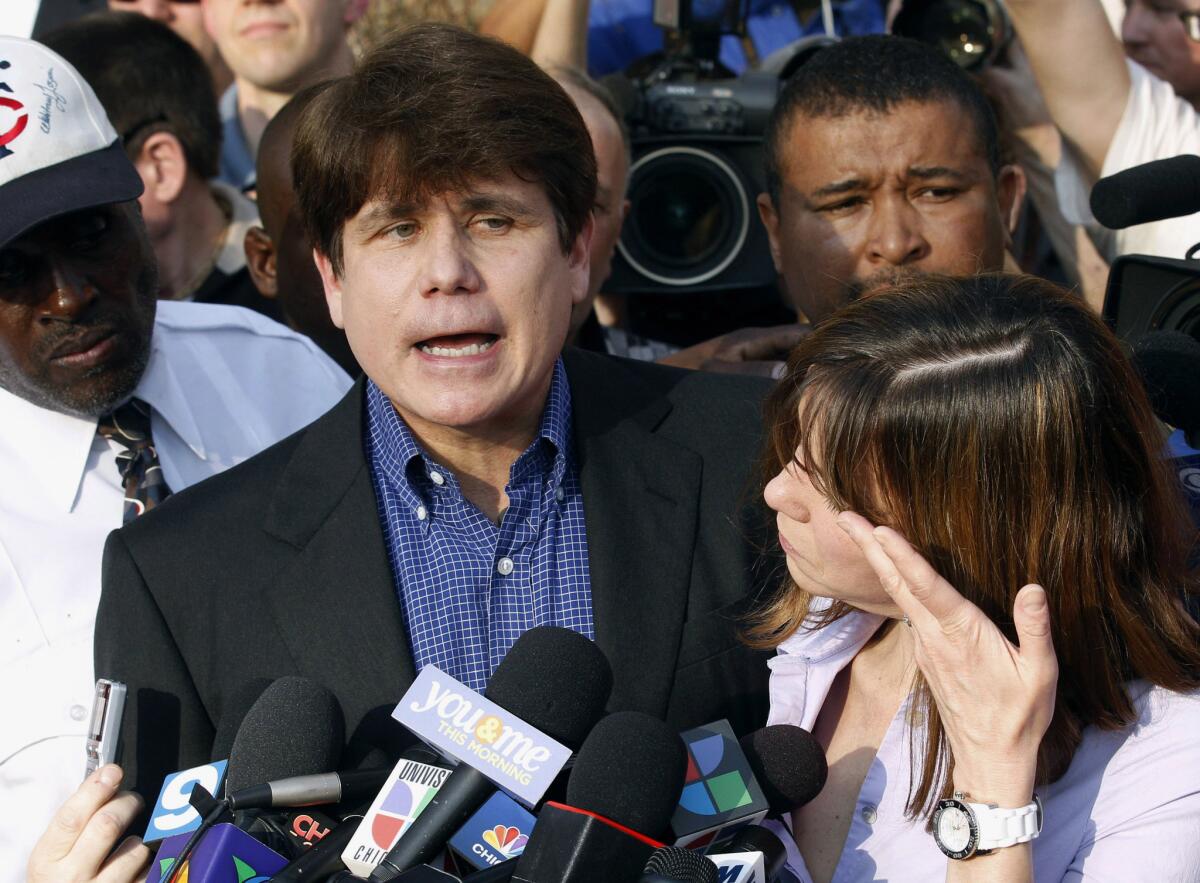 Former Illinois Gov. Rod Blagojevich speaks to the media outside his home in Chicago with his wife, Patti, shortly before heading to prison.