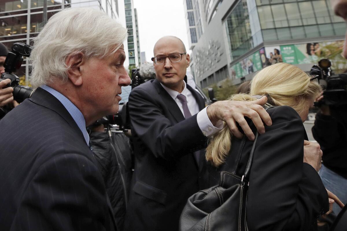 Gregory Abbott and Marcia Abbott outside Boston federal court in May