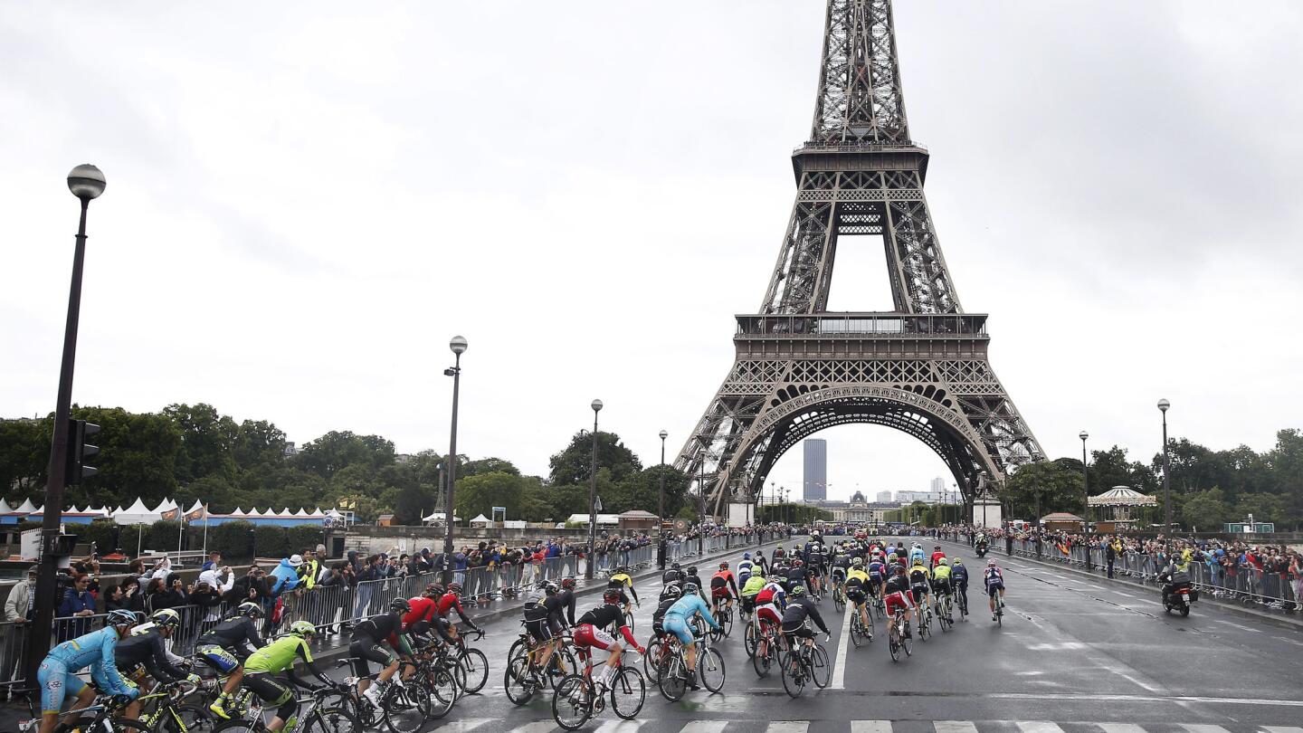 Peloton rides past Eiffel Tower