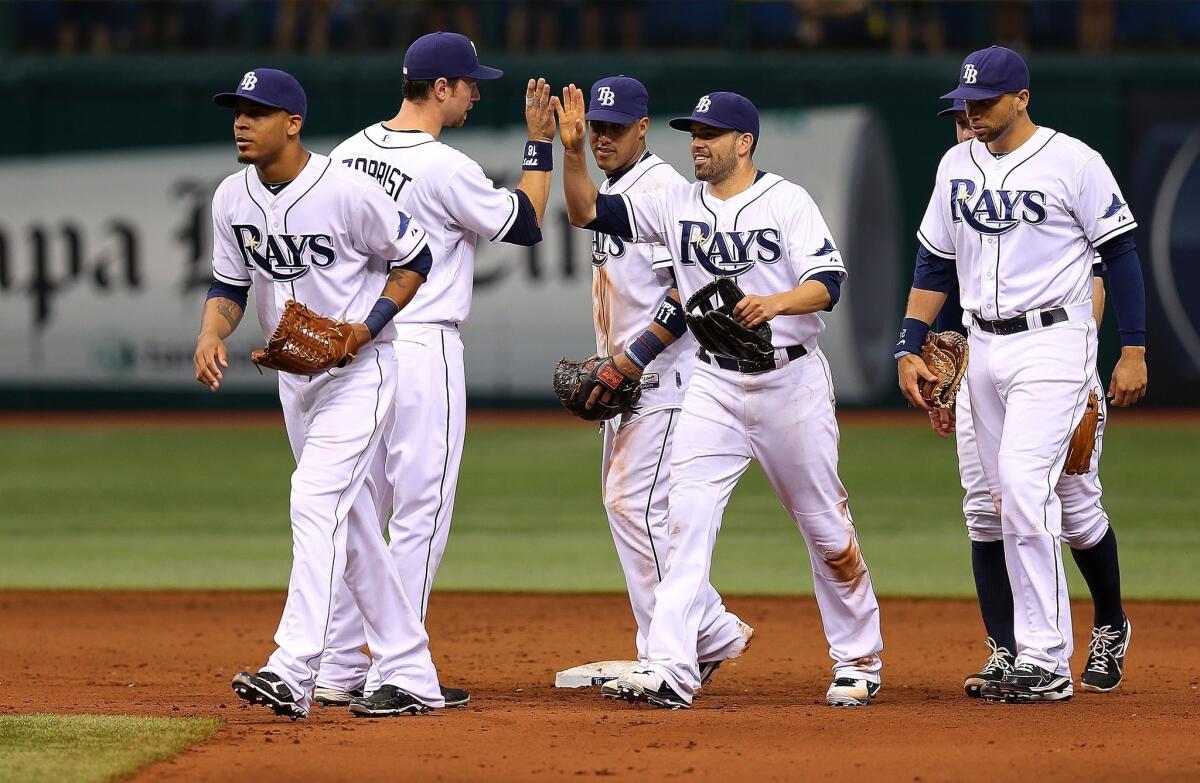 Tampa Bay Rays players celebrate their 5-1 victory Saturday over the Baltimore Orioles.