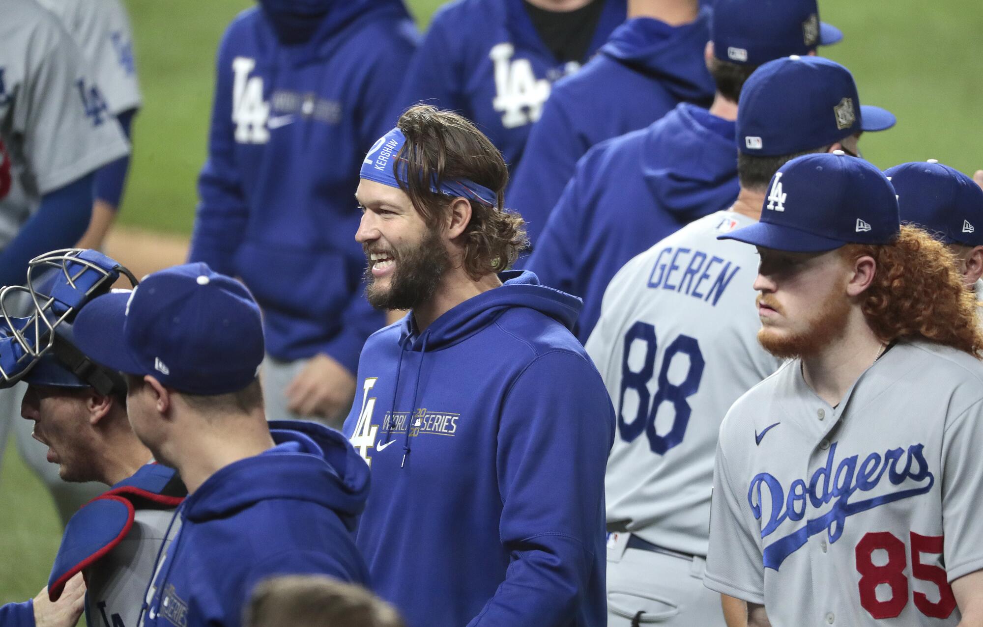Game 5 starter Clayton Kershaw, center, smiles after the Dodgers move to within one win of the World Series championship.