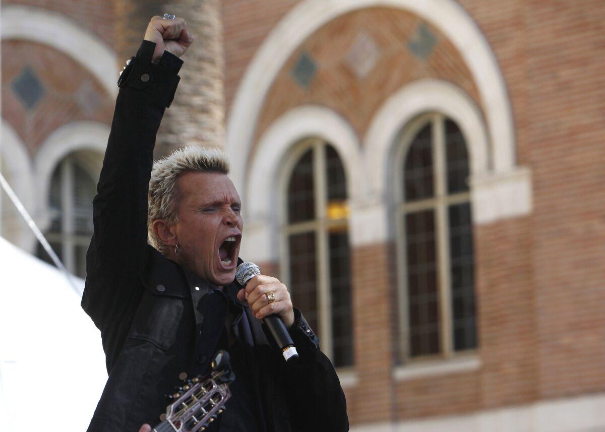 Billy Idol, author of "Dancing with Myself," performs a song after speaking about his book at the Los Angeles Times Festival of Books on the USC campus.