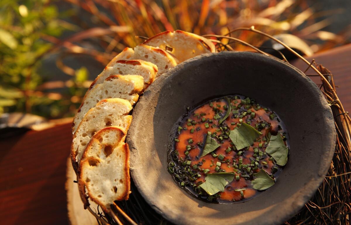 A meal often starts with sourdough with a reduced tomato puree. The dish is similar to the charred, half-baked rounds of sourdough with uni served at chef Phillip Frankland Lee's other restaurant, Scratch Bar.