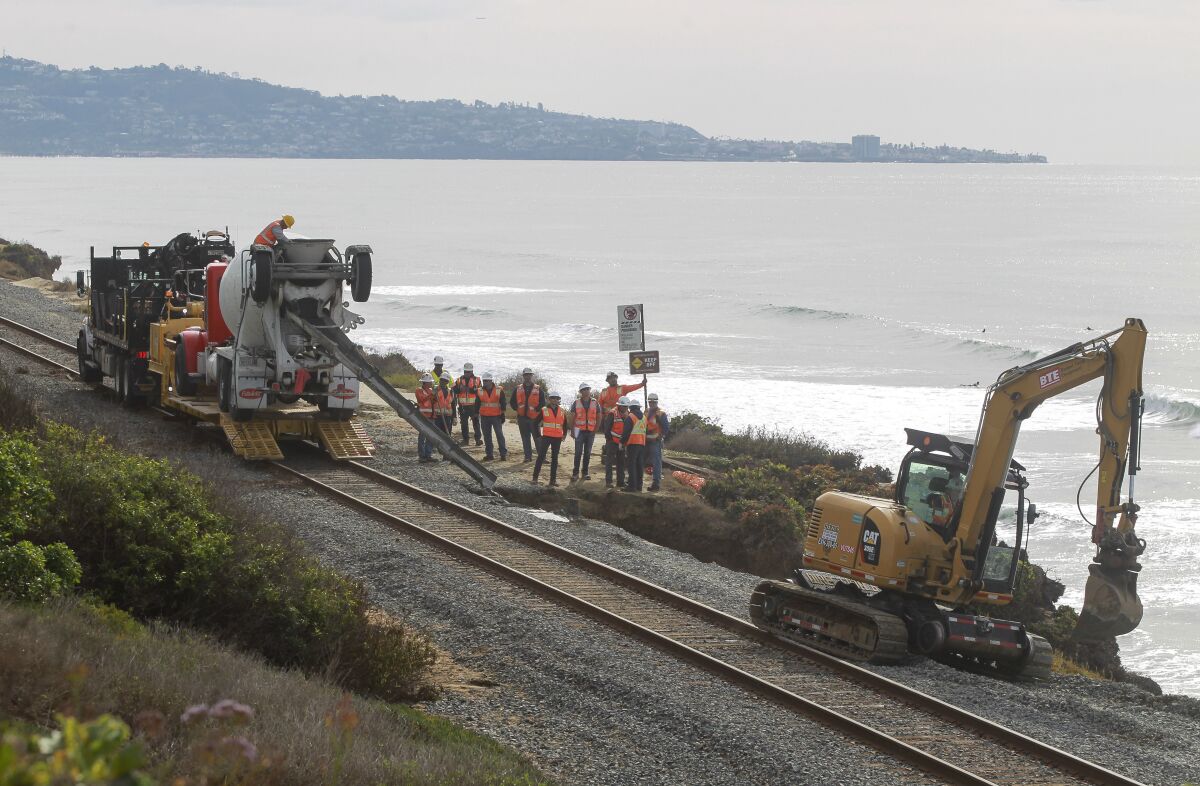 Workers repair erosion caused by a rainstorm in late November along the railroad tracks in Del Mar.