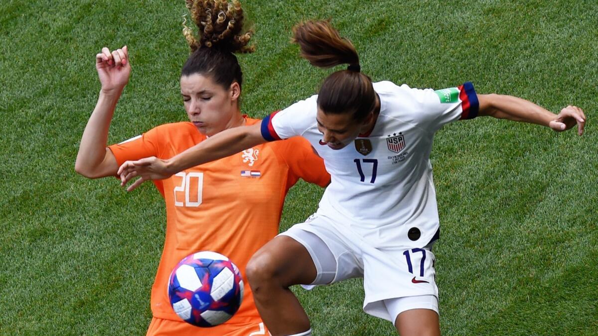 Netherlands defender Dominique Bloodworth, left, and U.S. forward Tobin Heath battle for the ball during the opening minutes of the Women's World Cup final in Lyon, France, on Sunday.
