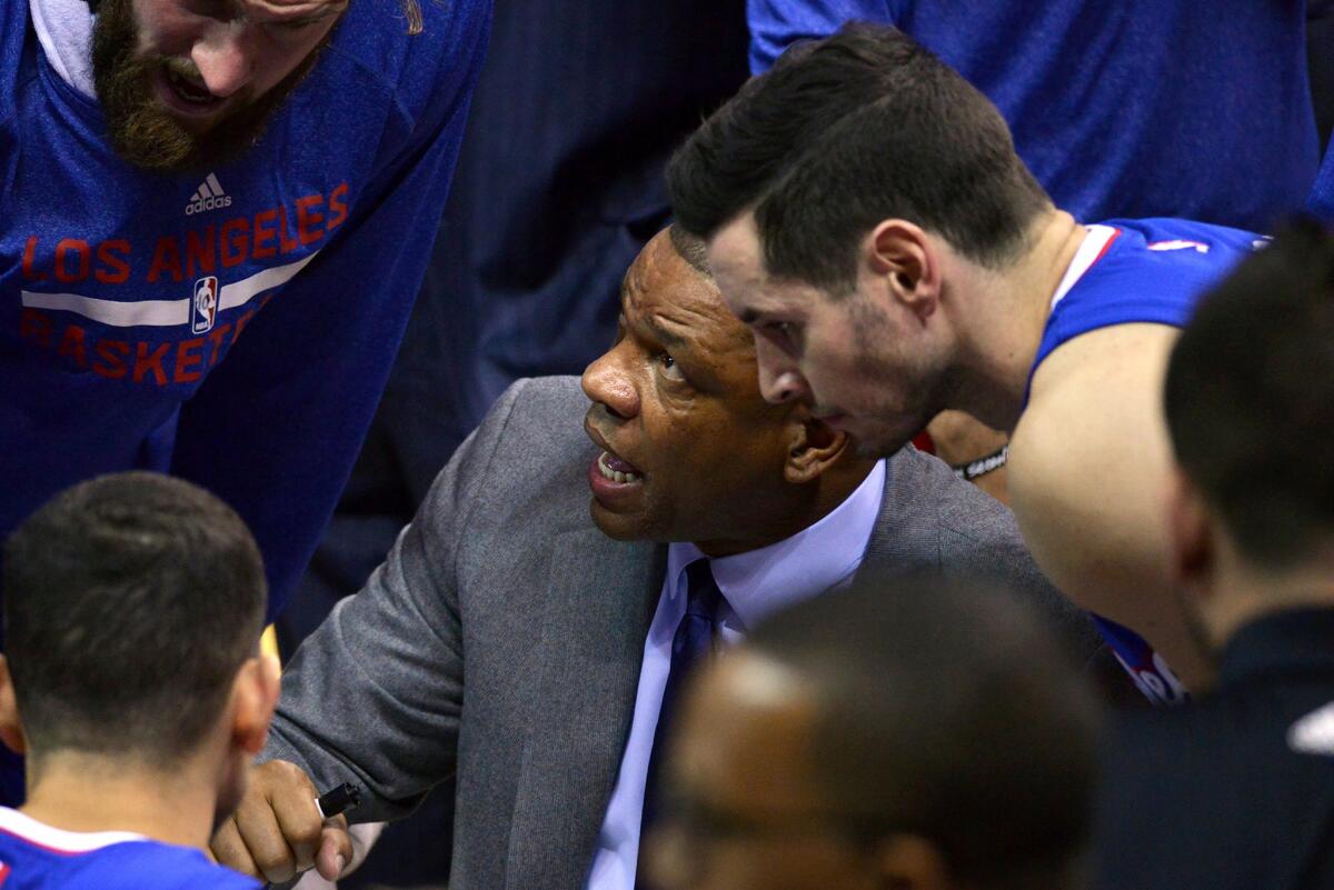 Coach Doc Rivers talks strategy with the Clippers during a timeout in the first half Friday night.