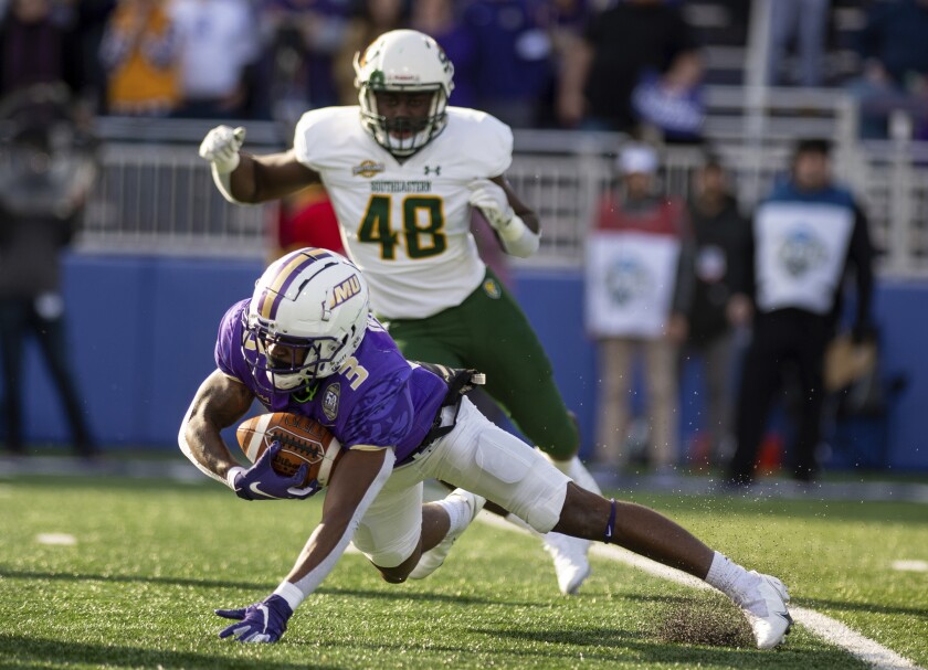 James Madison running back Solomon Vanhorse (3) loses his balance as he runs the ball up the field against Southeastern Louisiana during the first half of an NCAA college football playoff game in Harrisonburg, Va., Saturday, Dec. 4, 2021. (Daniel Lin/Daily News-Record Via AP)