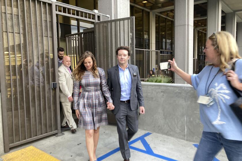 Actor Danny Masterson leaves Los Angeles superior Court with his wife Bijou Phillips after a judge declared a mistrial in his rape case in Los Angeles on Wednesday, Nov. 30, 2022. Jurors said they were hopelessly deadlocked at the trial of "That '70s Show" actor who was charged with the rape of three women, including a former girlfriend, between 2001 and 2003. (AP Photo/Brian Melley)