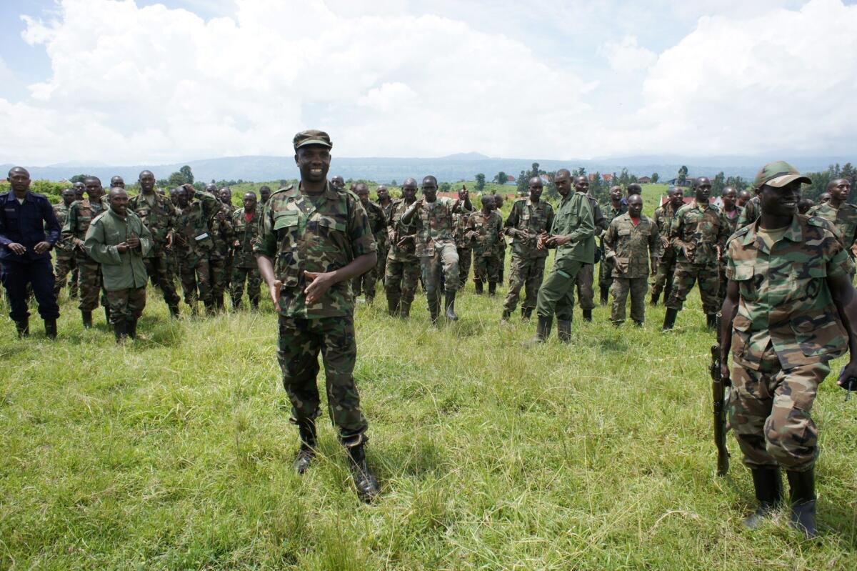 M23 rebels, with spokesman Vianney Kazarama in the left foreground, are pictured in April at the Rumangabo camp in the Democratic Republic of Congo. Peace talks between the rebels and the Congolese government have been suspended for months and an upsurge in fighting has occurred. A human rights group reported Thursday that M23 leaders have restored gold trafficking to finance their brutal rebellion.