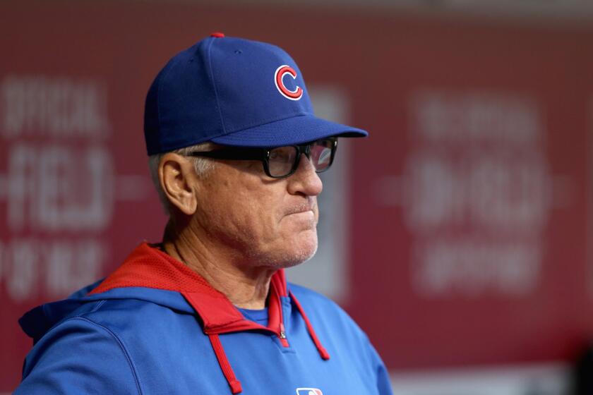 Chicago Cubs Manager Joe Maddon looks on from the dugout during his team's game against the Cincinnati Reds on April 24.