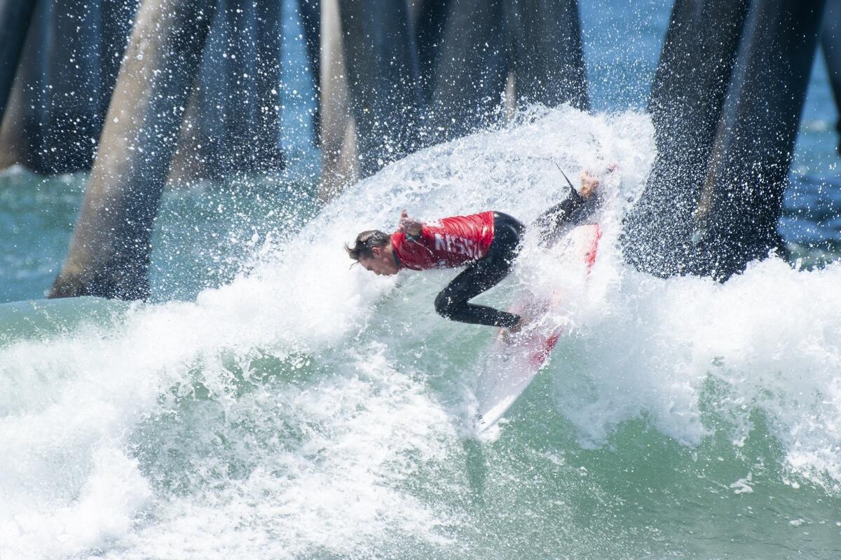 Sage Tutterow of Hawaii cuts back on a wave in round 4 of the men's open at the National Scholastic Surfing Assn. National Championships on Tuesday in Huntington Beach.