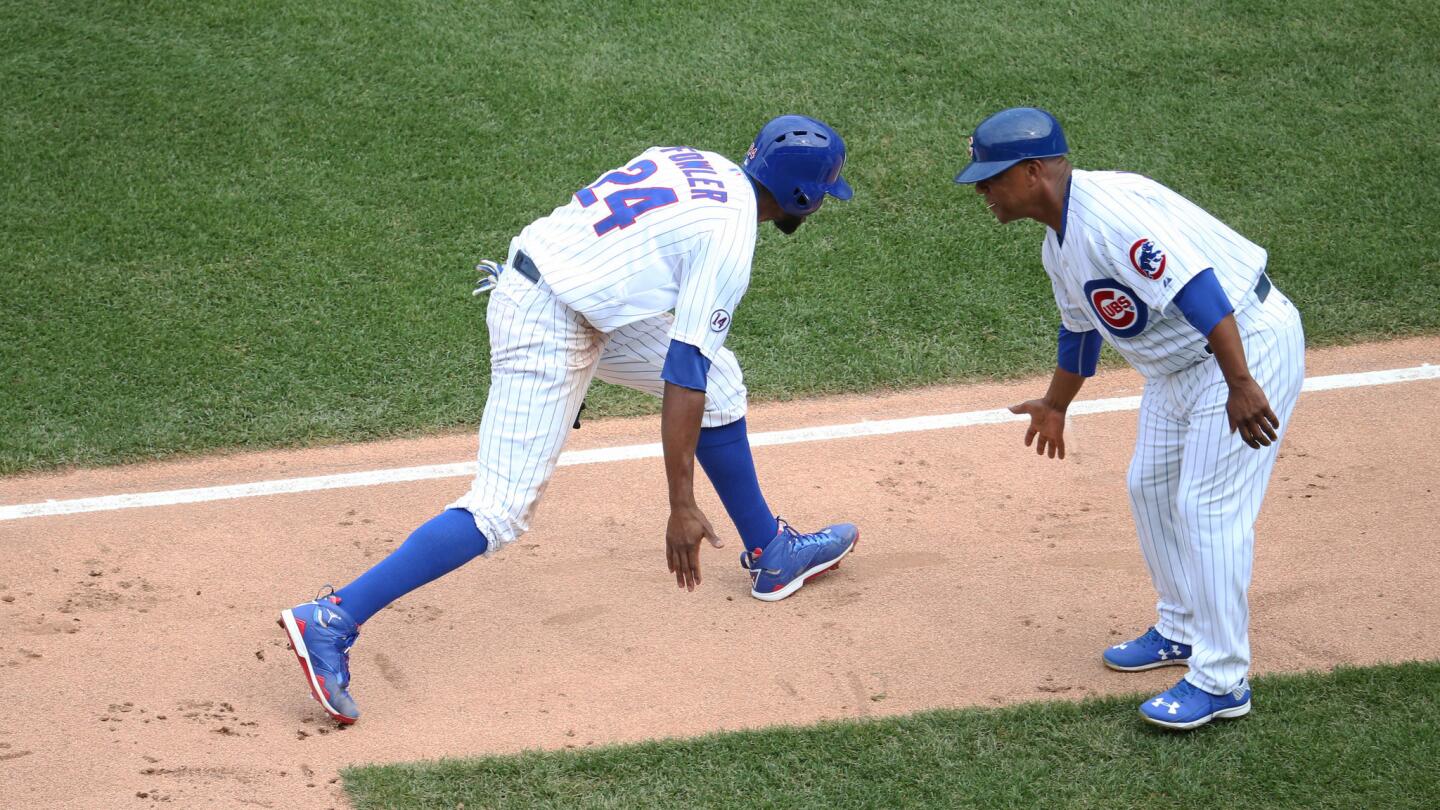 Cubs center fielder Dexter Fowler, left, gets a low-five from third base coach Fary Jones in the fifth inning.