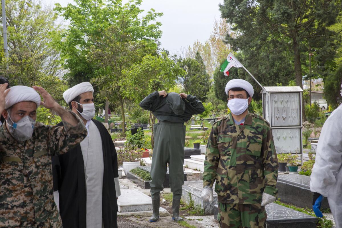 Volunteers prepare to wash the body of a COVID-19 victim in Qaem Shahr, Iran. According to custom, female corpses must be washed only by a woman.