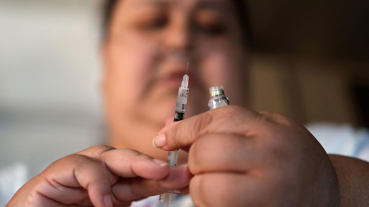 A woman with type 2 diabetes prepares to inject herself with insulin. (John Locher / AP)