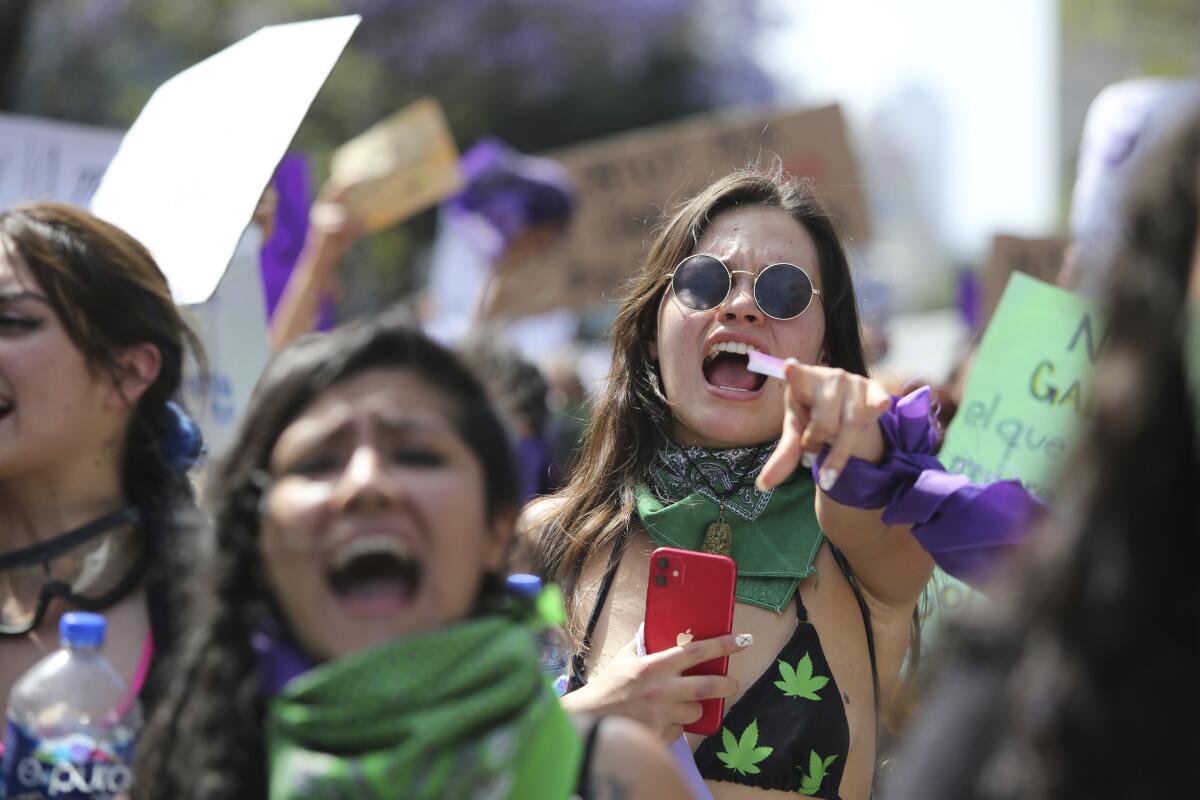 Women protest during a march to commemorate International Women's Day and protest against gender violence, in Mexico City, Monday, March 8, 2021. (AP Photo/Ginnette Riquelme)