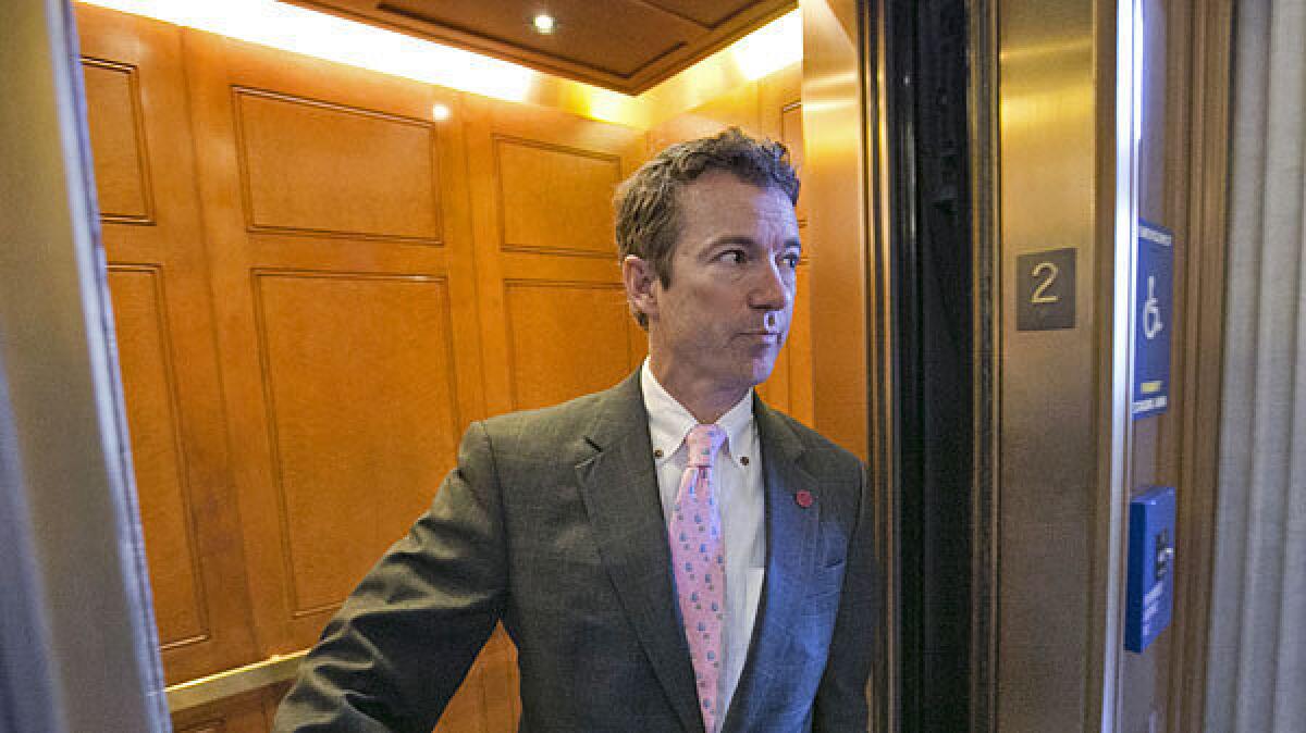 Sen. Rand Paul (R-Ky.) is questioned by reporters on Capitol Hill.