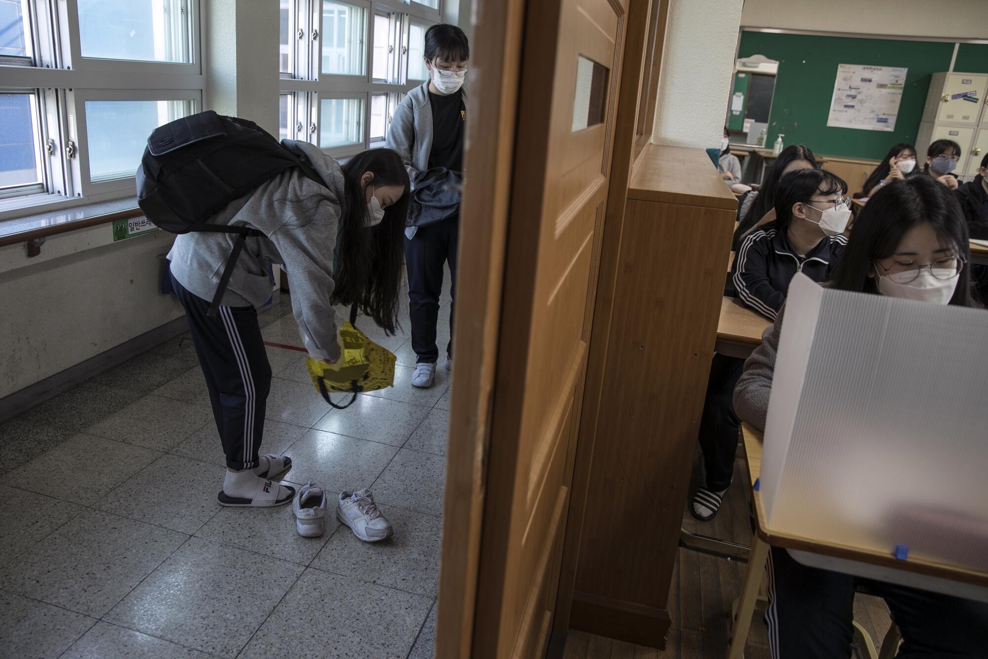 Students get ready for class at Gyungbuk Girls' High School in Daegu, South Korea, on May 20, 2020.