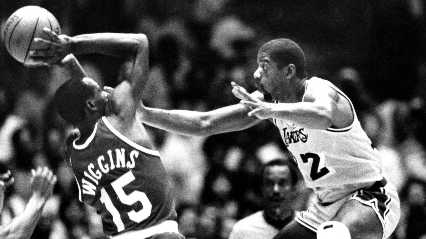 Houston Rockets guard Mitchell Wiggins tries to shoot over Lakers star Magic Johnson during a playoff game on May 10, 1986.