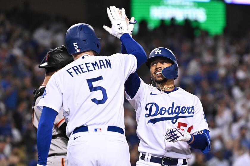 Los Angeles, California May 4, 2022-Dodgers Mookie Betts celebrates his solo home run against the Giants with Freddie Freeman in the sixth inning at Dodger Stadium Wednesday. (Wally Skalij/Los Angeles Times)