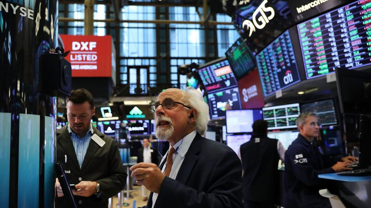 The Standard & Poor’s 500, Nasdaq composite and Russell 2000 indexes reached all-time highs Monday. Above, traders at the New York Stock Exchange on Friday.