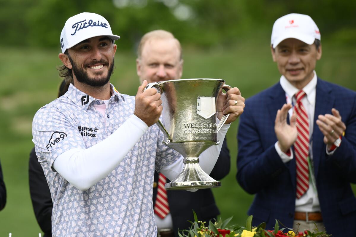 Max Homa holds the trophy after winning the Wells Fargo Championship.