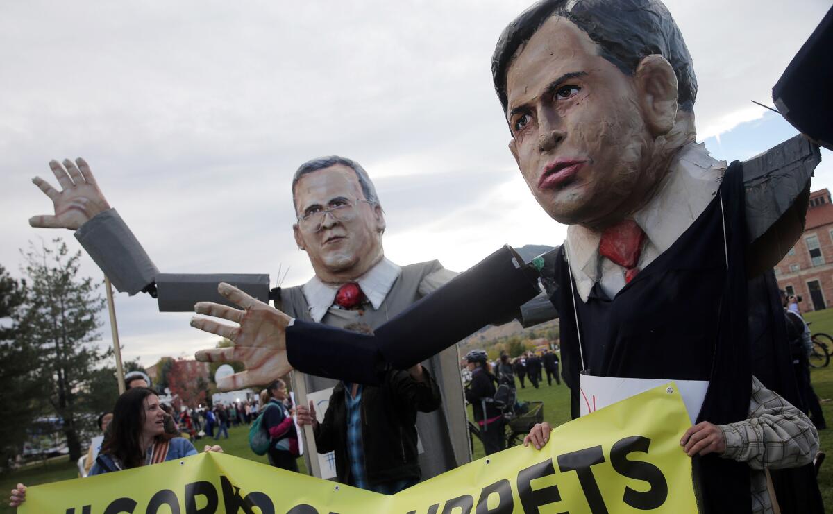Activists hold large puppets of Republican presidential candidates Jeb Bush, left, and Sen. Marco Rubio. Internal documents from the Bush campaign show that the candidate may have been planning an art party timed to the launch of the fairs in Miami Beach in December.