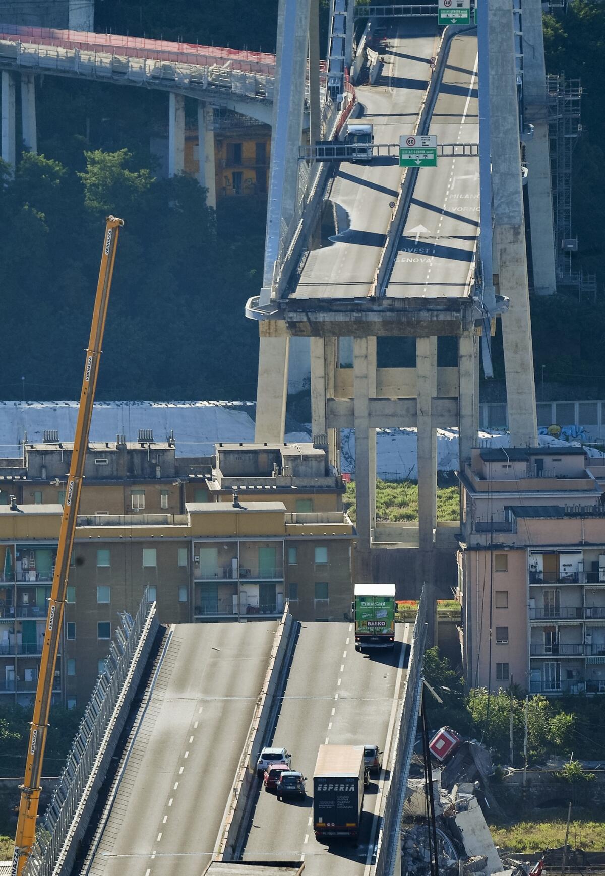 Vehicles are blocked on the collapsed Morandi highway bridge in Genoa, northern Italy, on Wednesday.