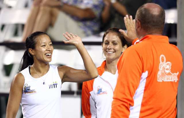 The Newport Beach Breakers' Anne Keothavong, left, gets a high five from Coach Trevor Kronemann after beating St. Louis Aces' Maria Sanchez.