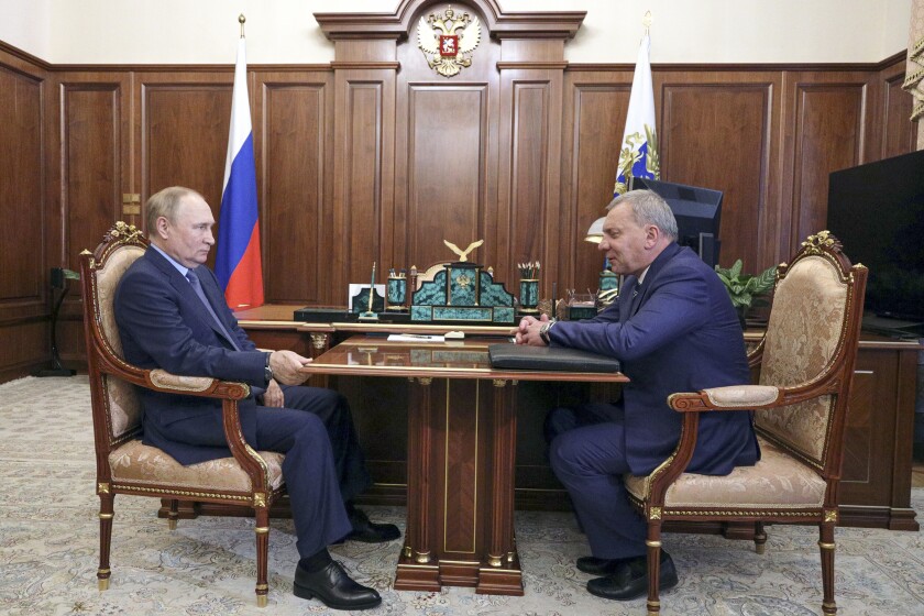 Russian President Vladimir Putin listens to Yuri Borisov, the new CEO of the Russian State Space Corporation "Roscosmos"