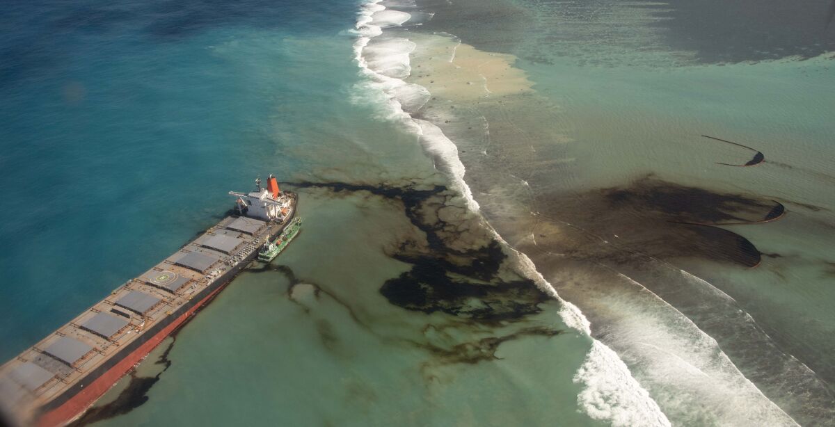 This photo provided by the French Defense Ministry shows oil leaking from the MV Wakashio, a bulk carrier ship that recently ran aground off the southeast coast of Mauritius,, Sunday Aug.9, 2020. The Indian Ocean island of Mauritius has declared a "state of environmental emergency" after the Japanese-owned ship that ran aground offshore days ago began spilling tons of fuel. (Gwendoline Defente/EMAE via AP)