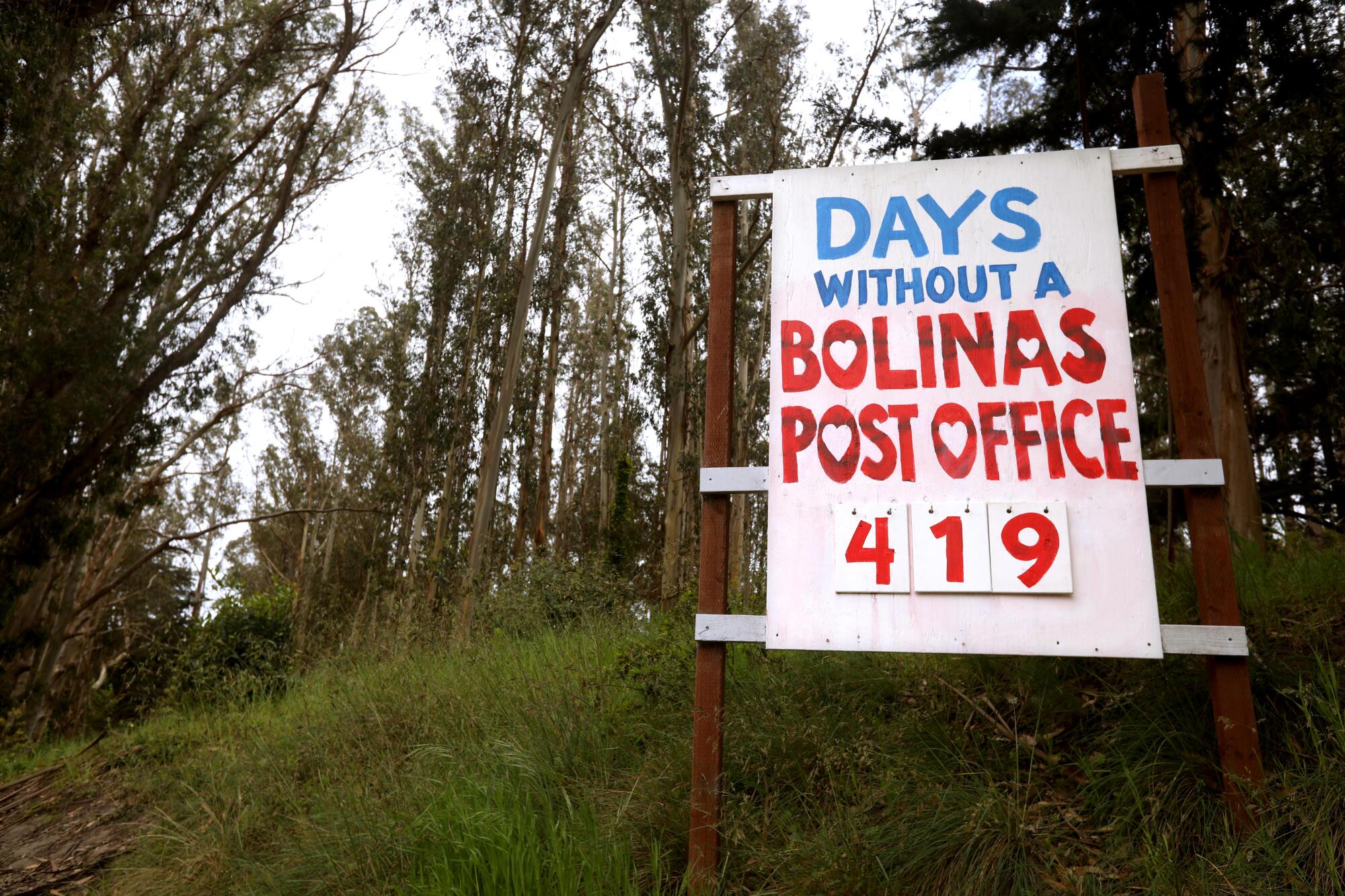 A roadway sign counts the days Bolinas has been without a post office.