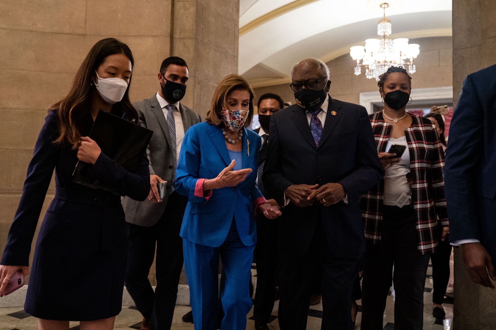 Nancy Pelosi, James Clyburn and others walk through the halls of the Capitol