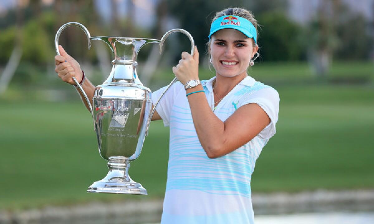 Lexi Thompson holds the Kraft Nabisco Championship trophy after winning Sunday at Mission Hills Country Club in Rancho Mirage.