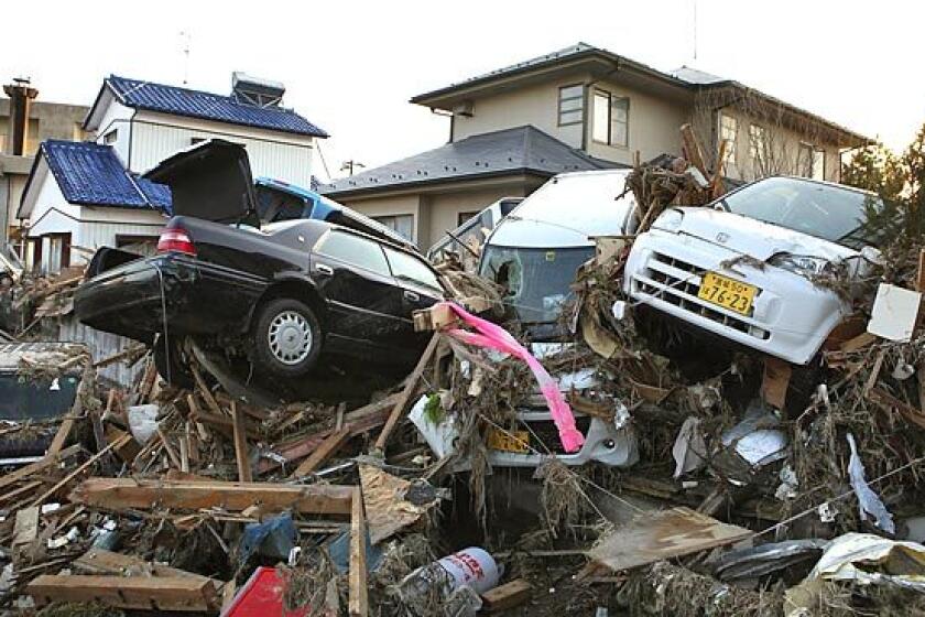 Vehicles and debris litter the Natori neighborhood hit hard by the tsunami.