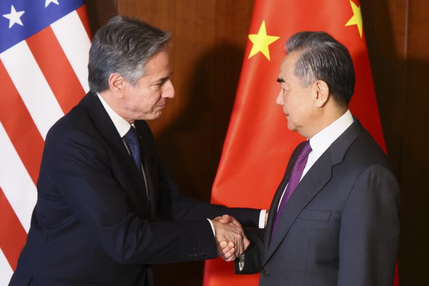 U.S. Secretary of State Antony Blinken and Chinese Foreign Minister Wang Yi shake hands as they meet on the side of the Munich Security Conference in Munich, Germany, Friday, Feb. 16, 2024. (Wolfgang Rattay/Pool via AP)