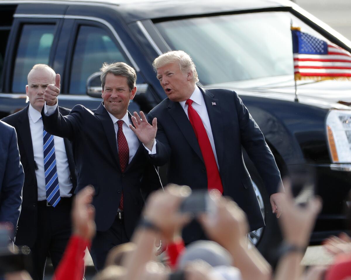 Brian Kemp and President Trump with a motorcade behind them