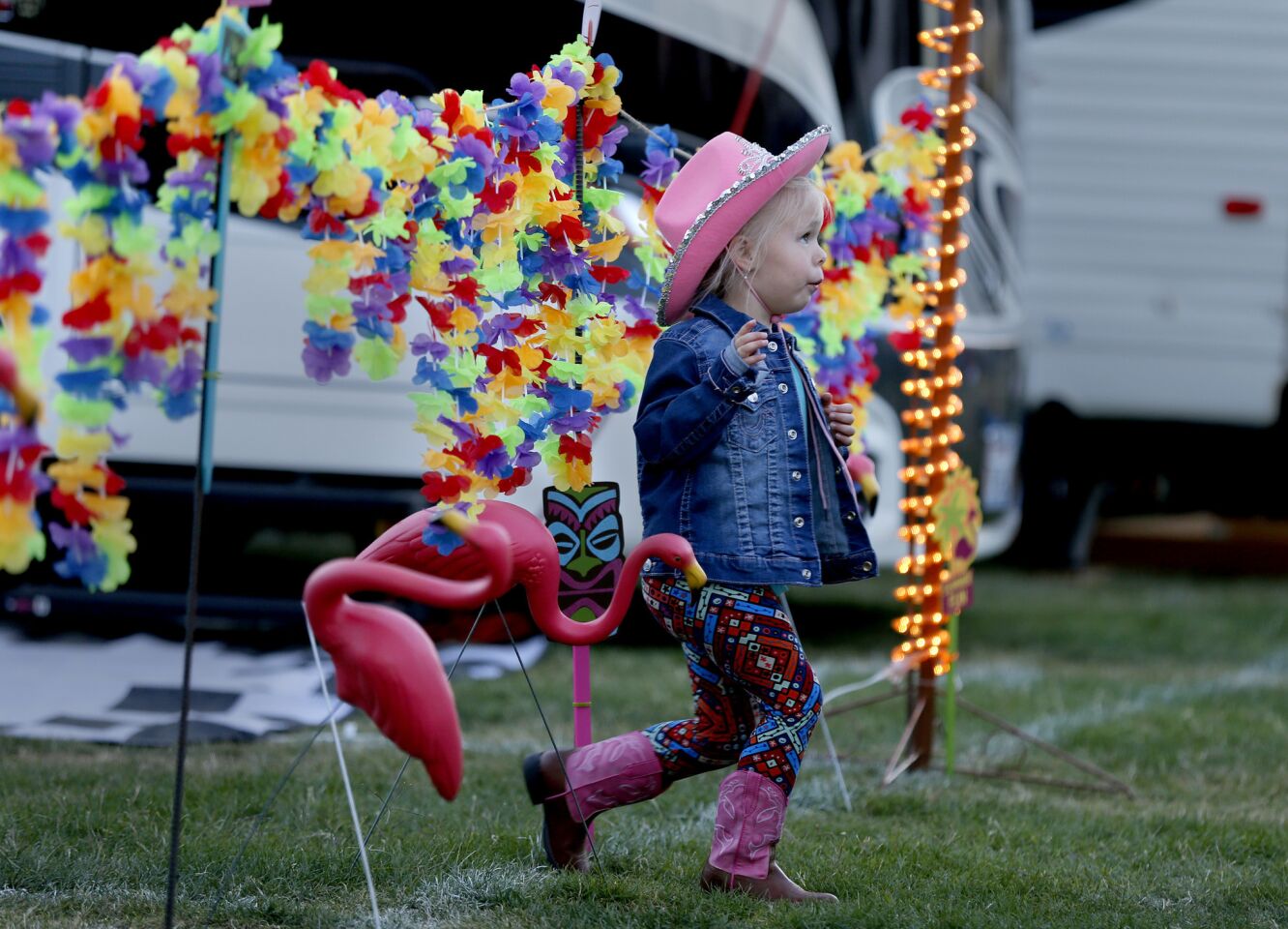Madisyn Recupido, 4, of Beaumont, who is attending her fourth Stagecoach festival, sports pink boots and hat while checking out plastic pink flamingos in the RV Resort at the Empire Polo Club in Indio.