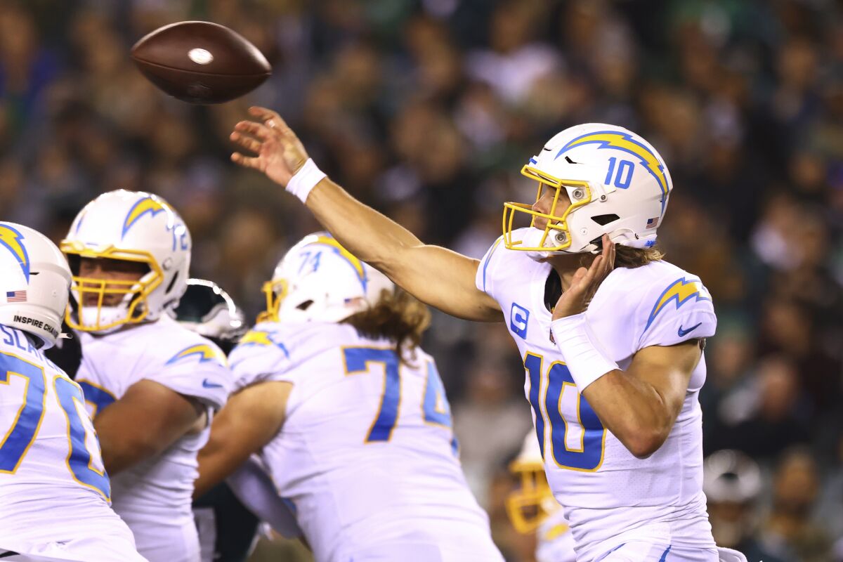 The Chargers quarterback Justin Herbert passes behind good protection.