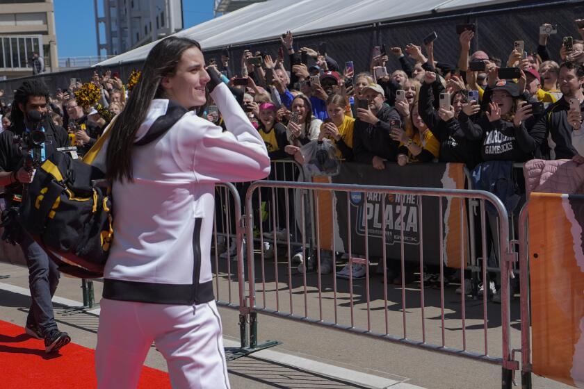 Fans cheer as Iowa's Caitlin Clark arrives for the NCAA Women's championship basketball game against South Carolina