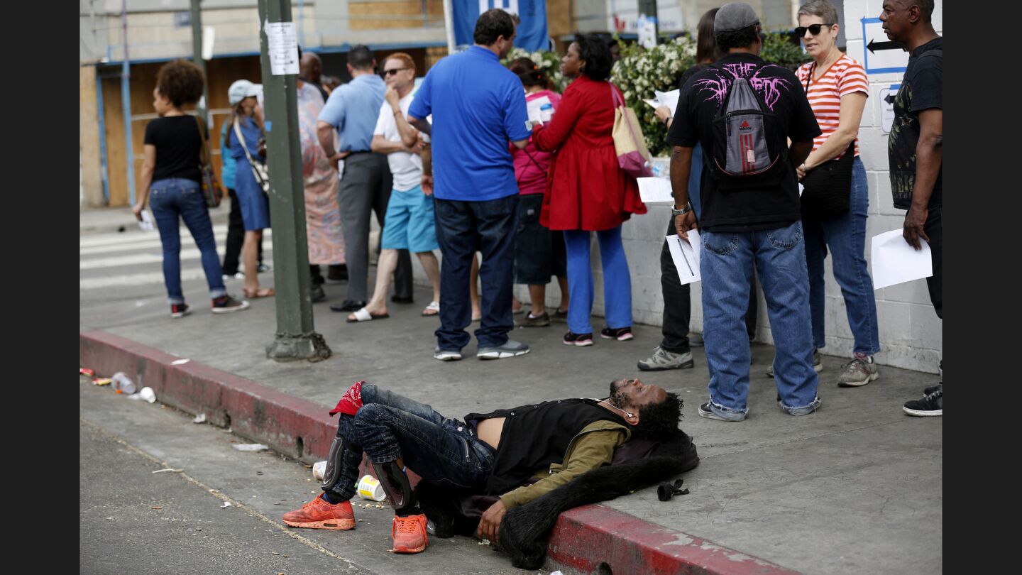People line up to vote on the corner of 5th and San Julian streets on skid row.