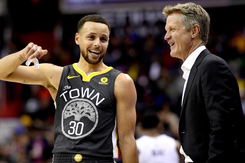 Golden State Warriors guard Stephen Curry, left, laughs with Warriors cach Steve Kerr during the first half of the team's NBA basketball game against the Washington Wizards, Wednesday, Feb. 28, 2018, in Washington. (AP Photo/Nick Wass)
