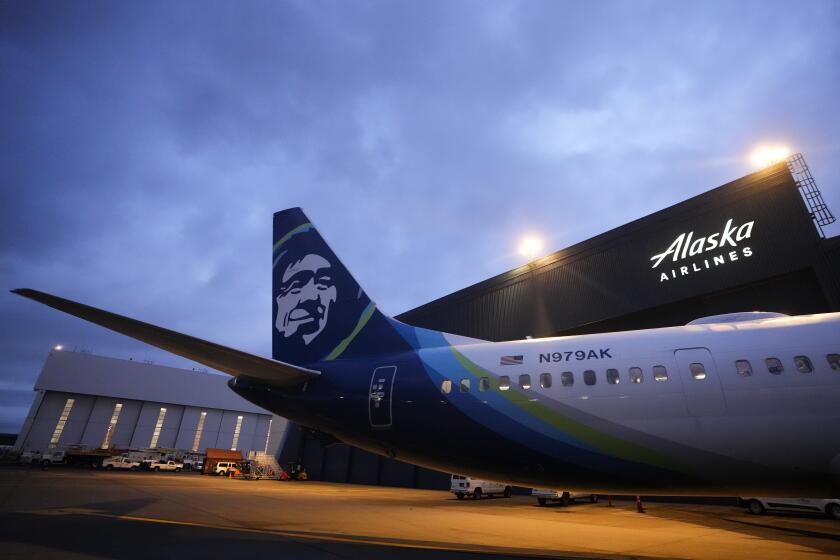 FILE - An Alaska Airlines Boeing 737 Max 9 with a door plug aircraft awaits inspection at the airline's hangar at Seattle-Tacoma International Airport Wednesday, Jan. 10, 2024, in SeaTac, Wash. The National Transportation Safety Board is sanctioning Boeing for sharing information with the media, Thursday, June 27, about the 737 Max 9 door plug investigation that it wasn't supposed to. (AP Photo/Lindsey Wasson)