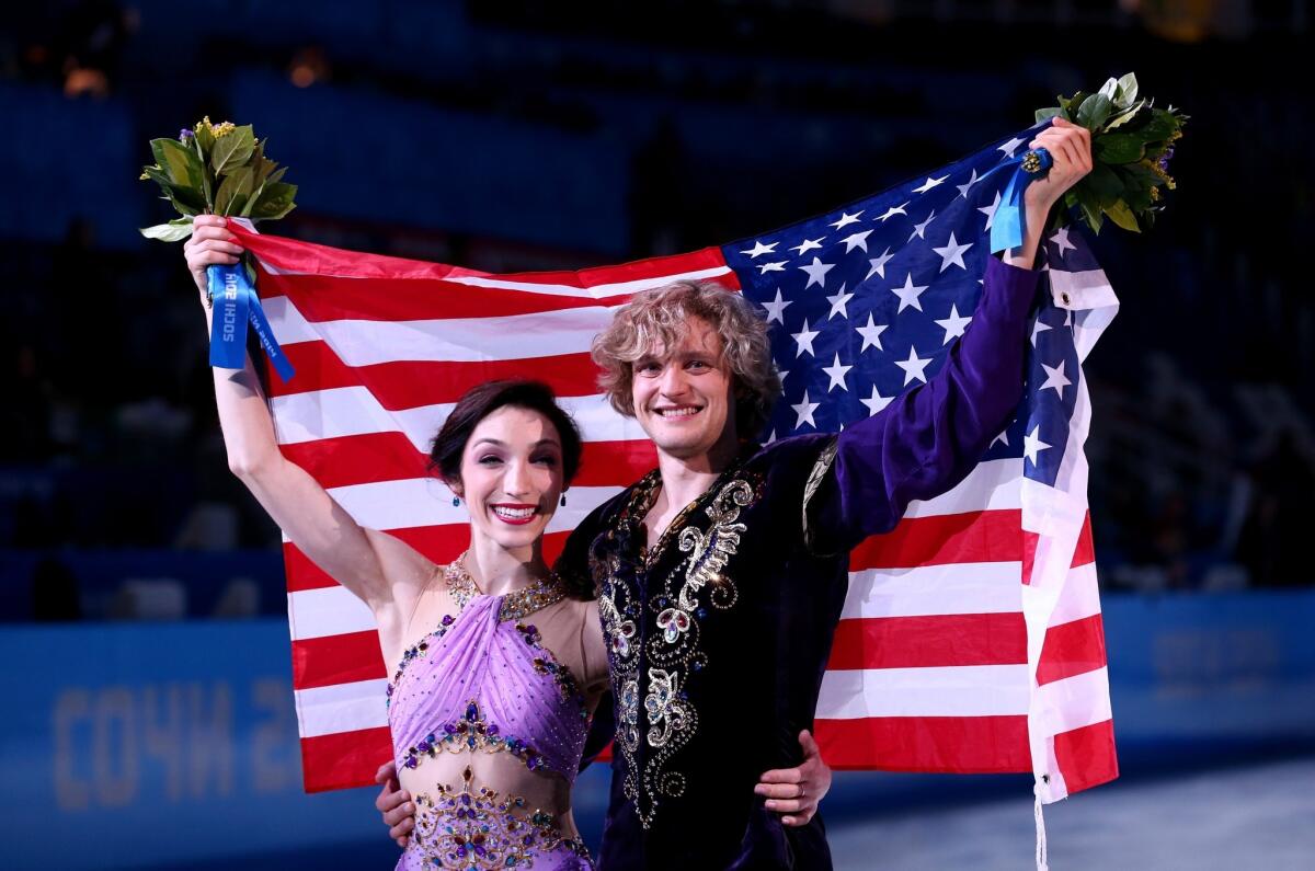Gold medalists Meryl Davis and Charlie White of the United States celebrate during the flower ceremony for the Figure Skating Ice Dance on Day 10 of the Sochi 2014 Winter Olympics at Iceberg Skating Palace on February 17, 2014 in Sochi, Russia.