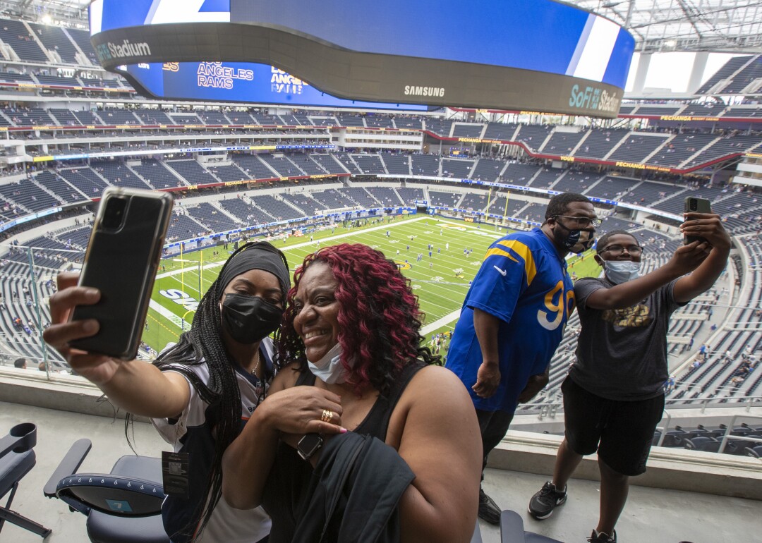 Maleka March, left, takes a photo with her mom Tina March before the game.