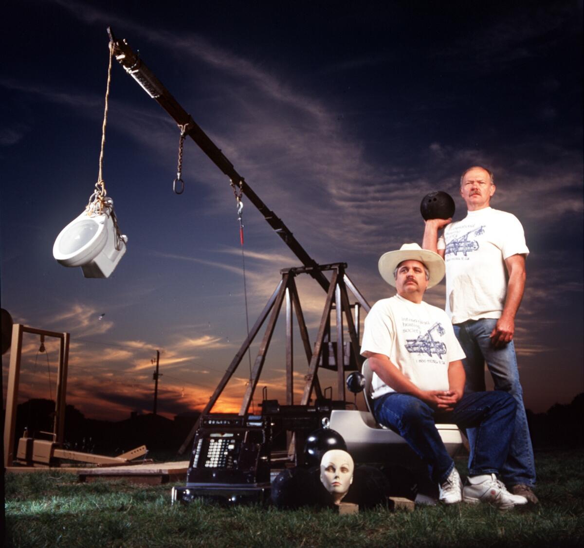 John Quincy, left, and Richard Clifford built a trebuchet with a 24-foot throwing arm. They named it "Baby Thor."