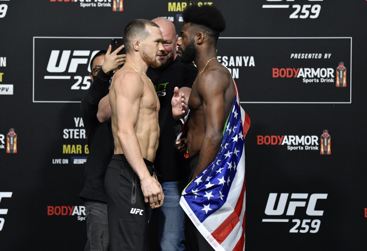Petr Yan, left, and Aljamain Sterling face off during the UFC 259 weigh-in Friday in Las Vegas.