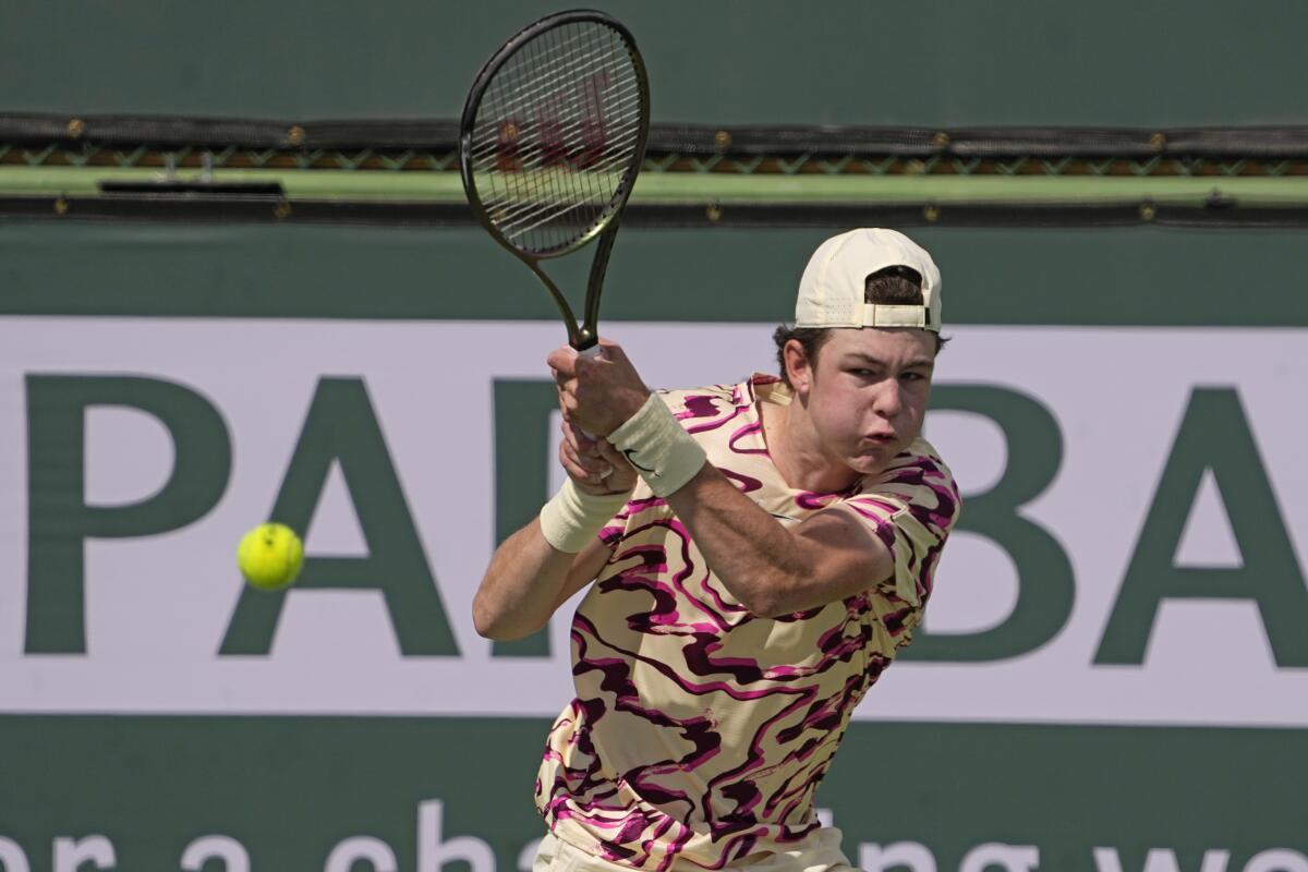 Jagger Leach returns a shot to Stiles Brockett at the BNP Paribas Open tennis tournament Wednesday, March 15, 2023, in Indian Wells, Calif. 15-year-old son of Lindsay Davenport, a three-time major champion and former No. 1-ranked player. Leach has won three ITF World Tennis Tour junior titles this year.(AP Photo/Mark J. Terrill)